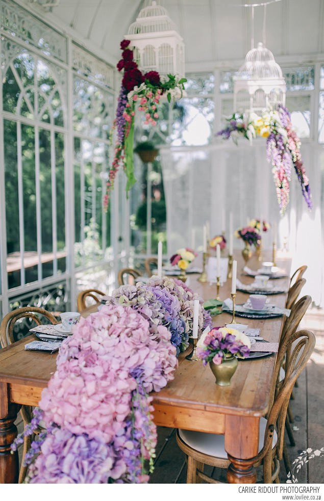 Bridal styled shoot with hydrangea table runner in a greenhouse