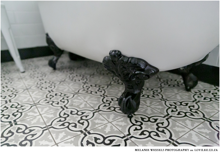 Bathroom with white subway inspired tiles and victorian style bath by Union Tiles