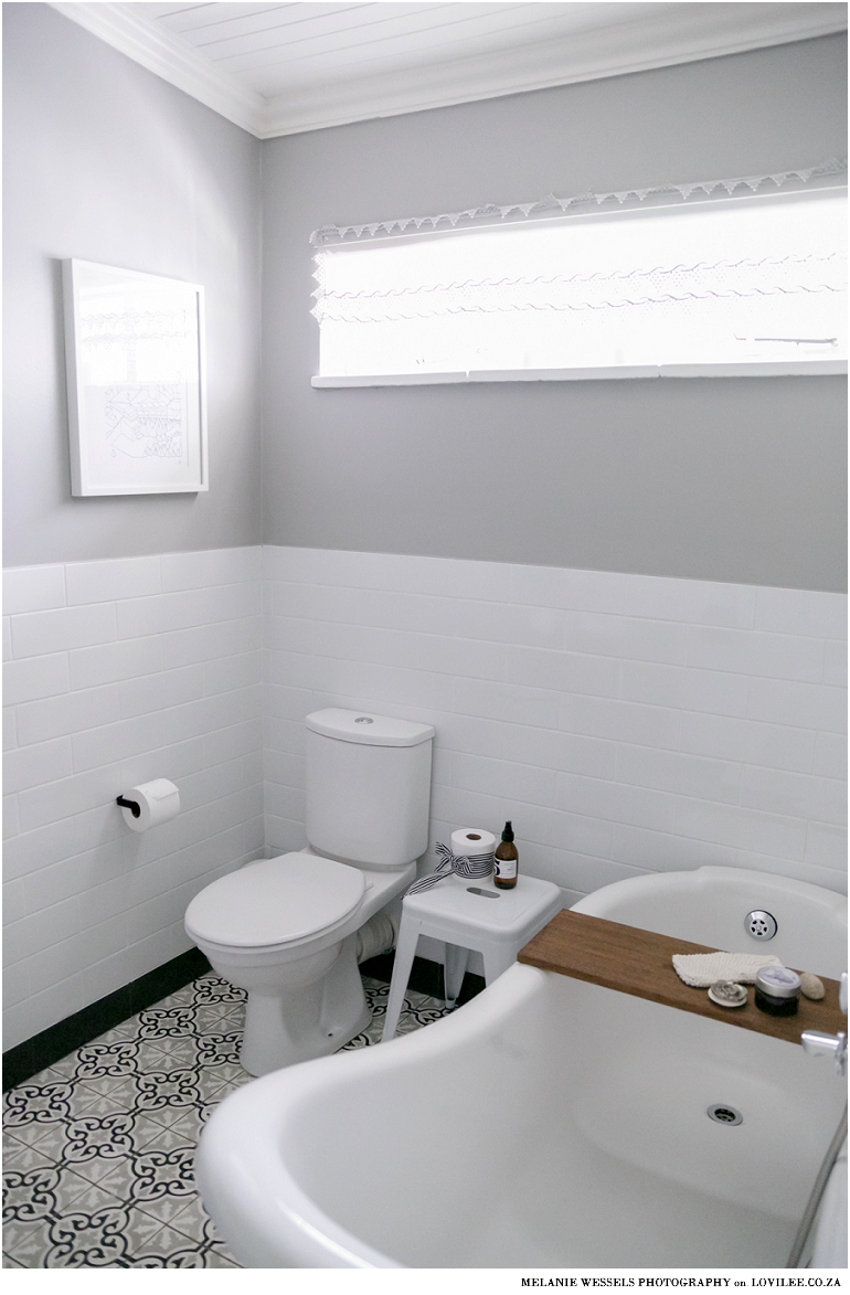 Bathroom with white subway inspired tiles and victorian style bath by Union Tiles