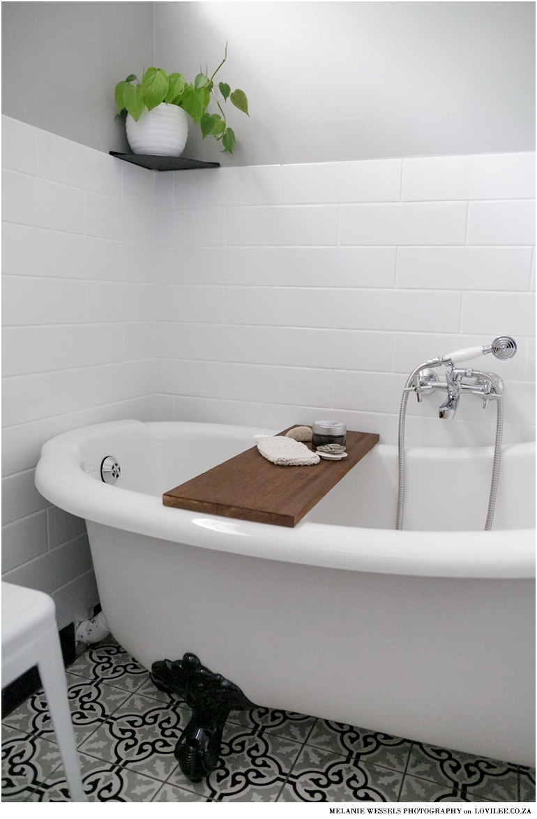 Bathroom with white subway inspired tiles and victorian style bath by Union Tiles