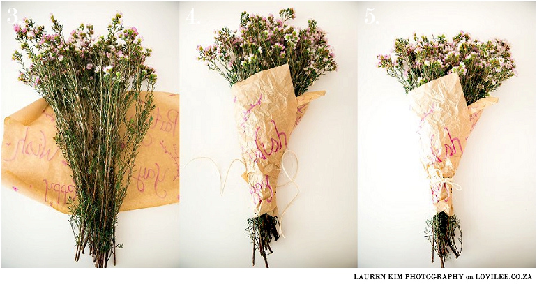 Bouquet wrapped in brown paper with writing on