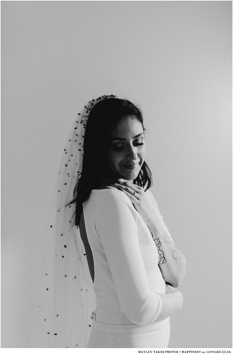 Black and white bridal portrait with confetti veil