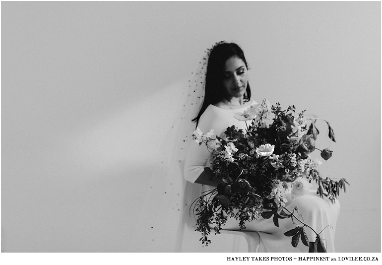 Black and white bridal portrait with confetti veil