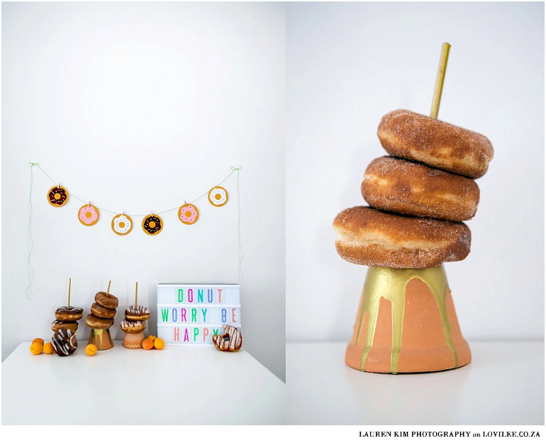 Donut candy table set up with DIY paper garland and donut stands