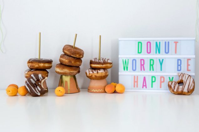 Donut party candy table set up with DIY donut stands