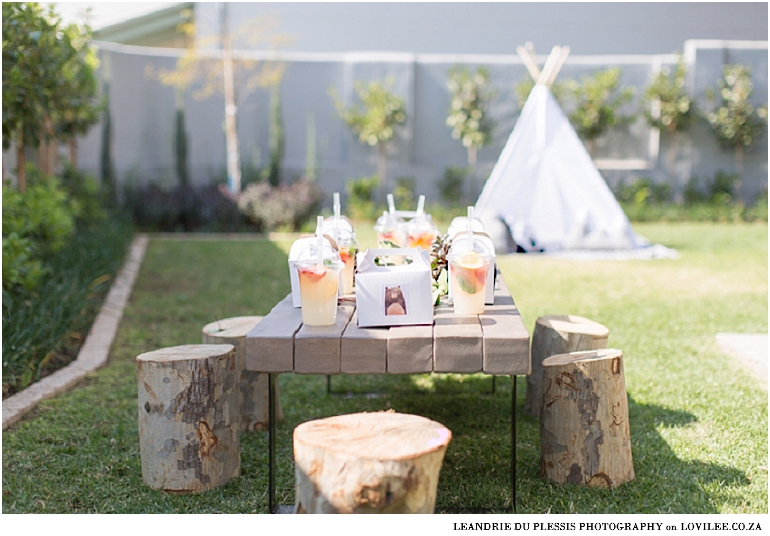 Forest theme kids party with tree stump chairs