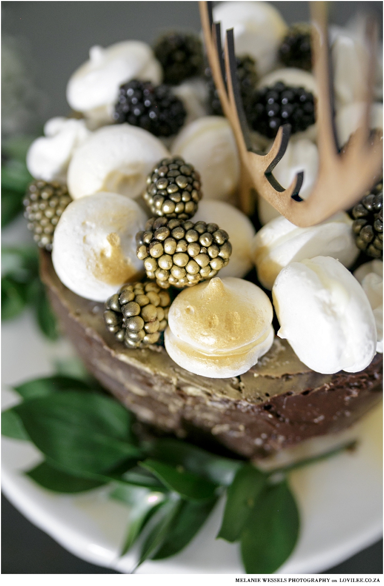 Black and white Christmas table with a Christmas cake and antler cake topper by Lovilee