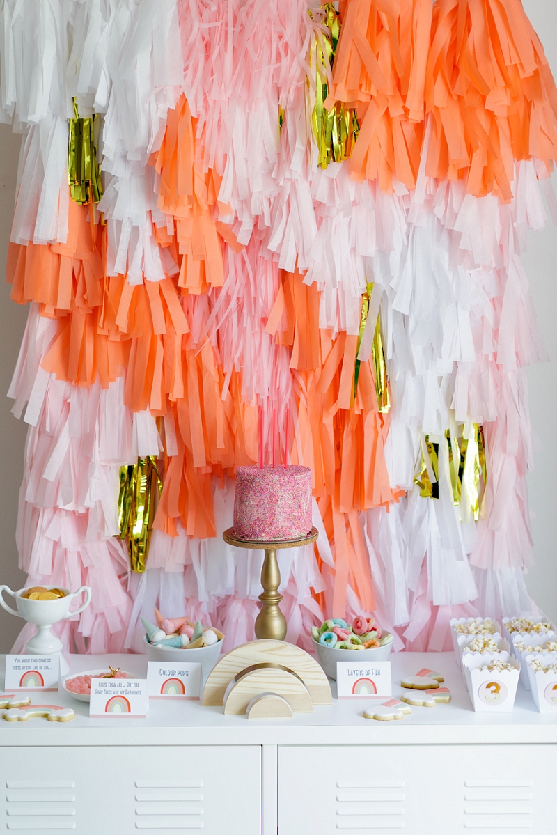 Rainbow Party candy table with DIY paper tassel backdrop