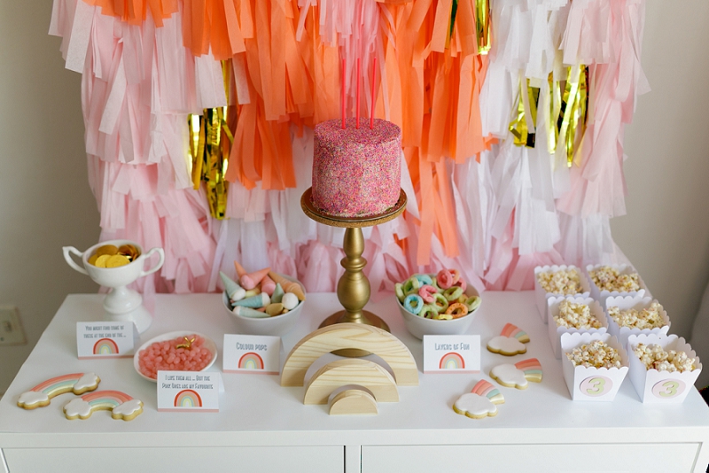 Rainbow Party candy table with DIY paper tassel backdrop